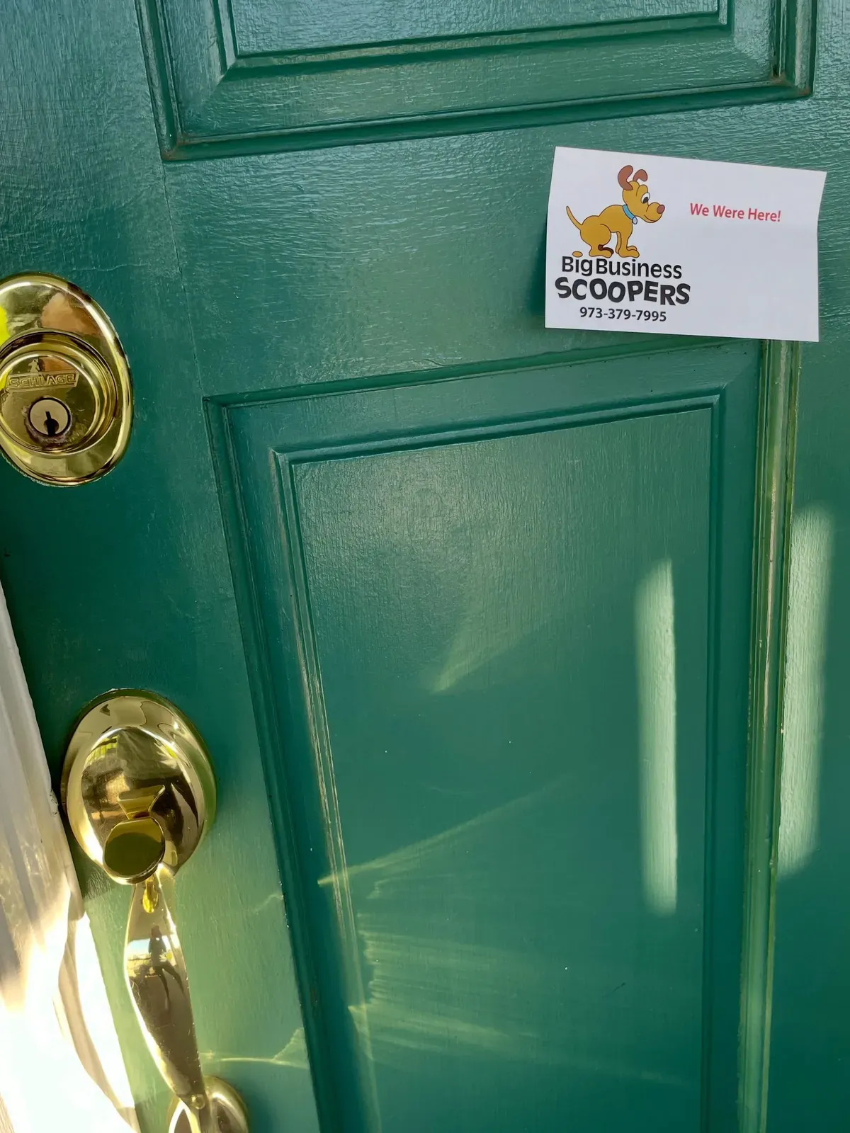 A Big Business Scoopers visit tag hung on a client's front door