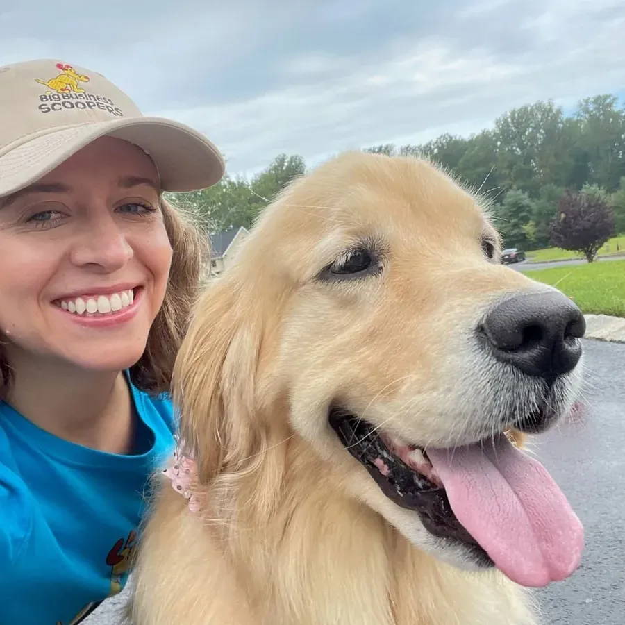 Emily LaBeaume, owner of Big Business Scoopers, with a golden retriever