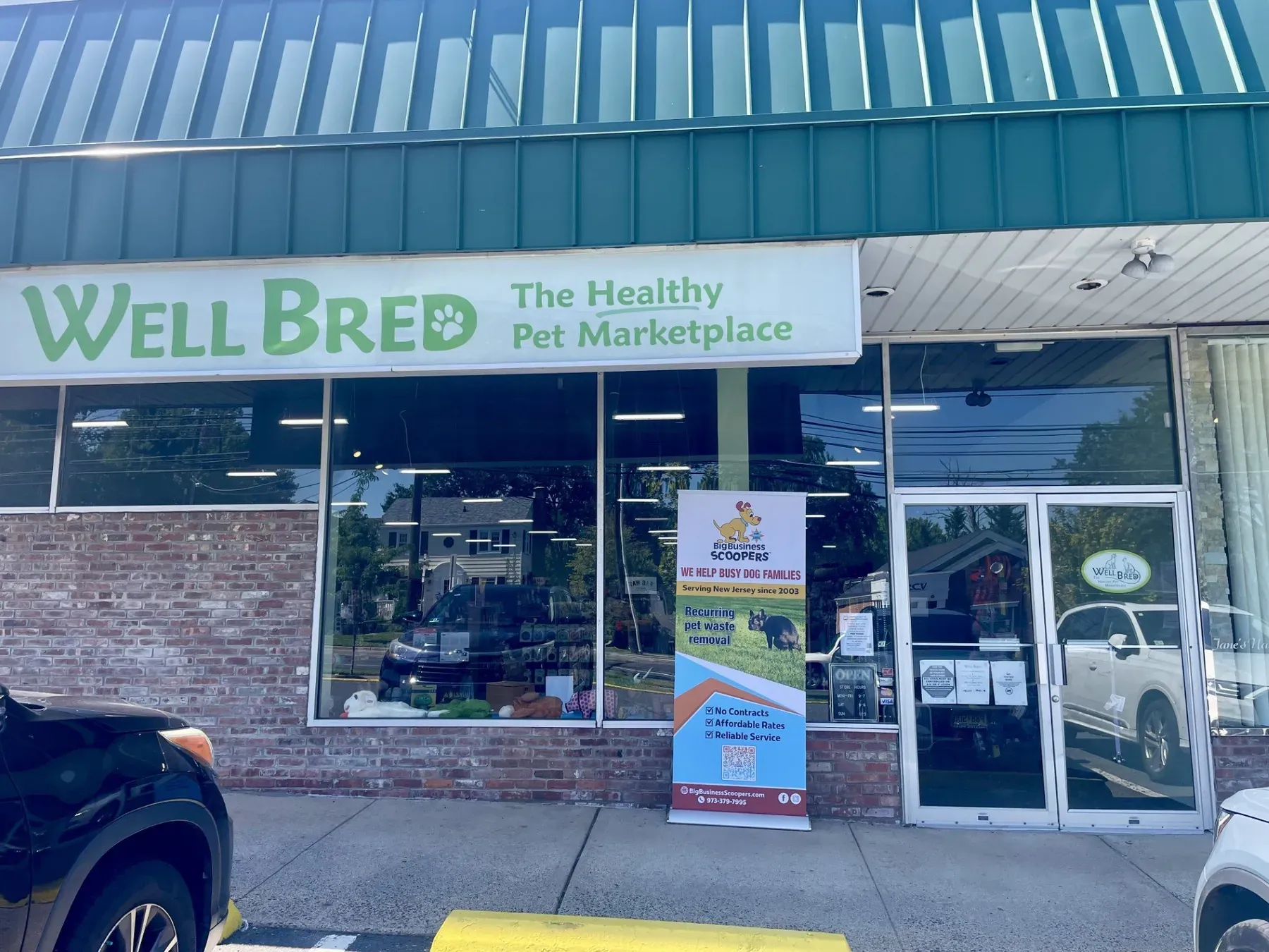 The Well Bred pet store in Madison with a Big Business Scoopers banner in the window